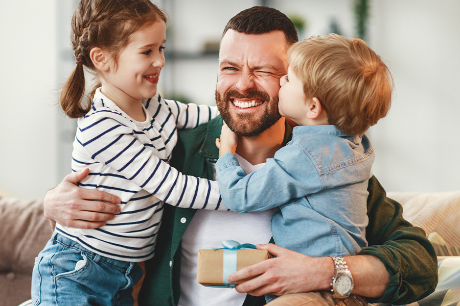 boy and girl giving their father a father's day gift