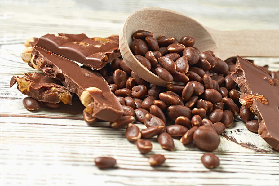 chocolate and cacao nuts displayed on a rustic wooden table