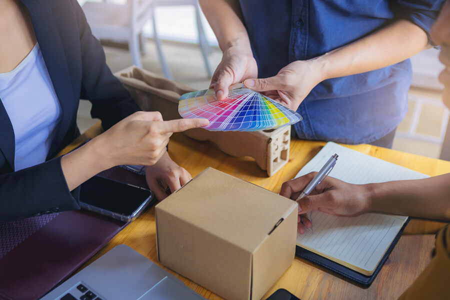 A team designing a personalized box of chocolates, featuring a box and color swatch