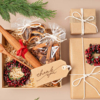 A festive gift box filled with cookies, a wooden spoon, and a gift tag, promoting sustainable corporate chocolate gifting