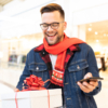 A man stands with a gift box